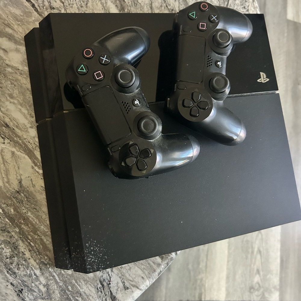 Sony PlayStation 4 Console with DualShock Controllers - Black. Works great